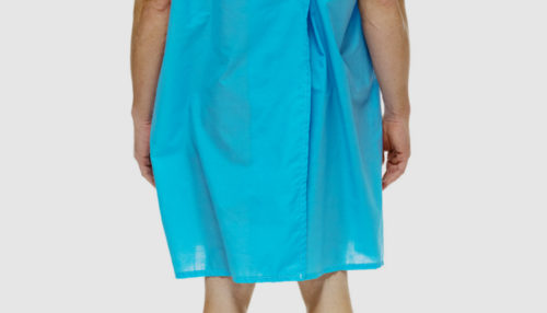 A patient is seen from behind wearing a blue gown